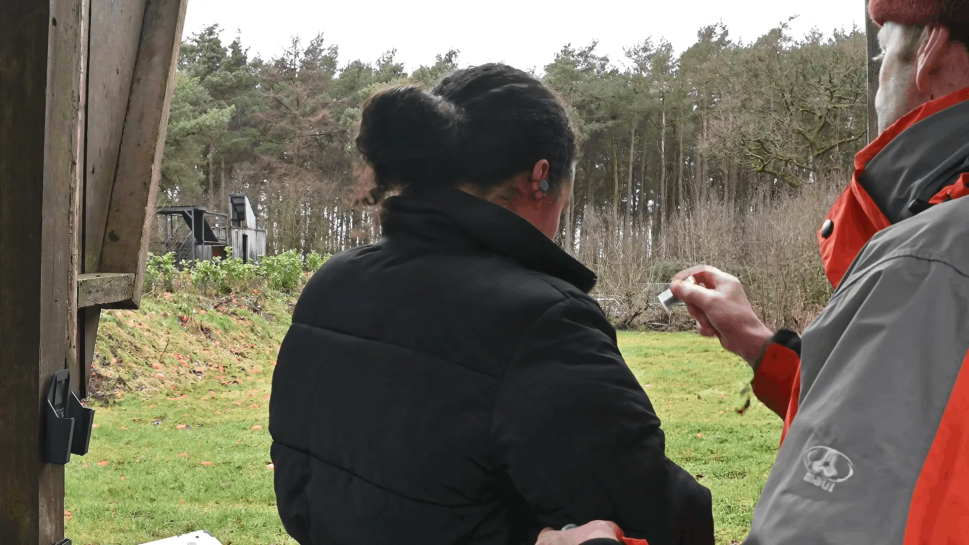 women getting shooting instruction 